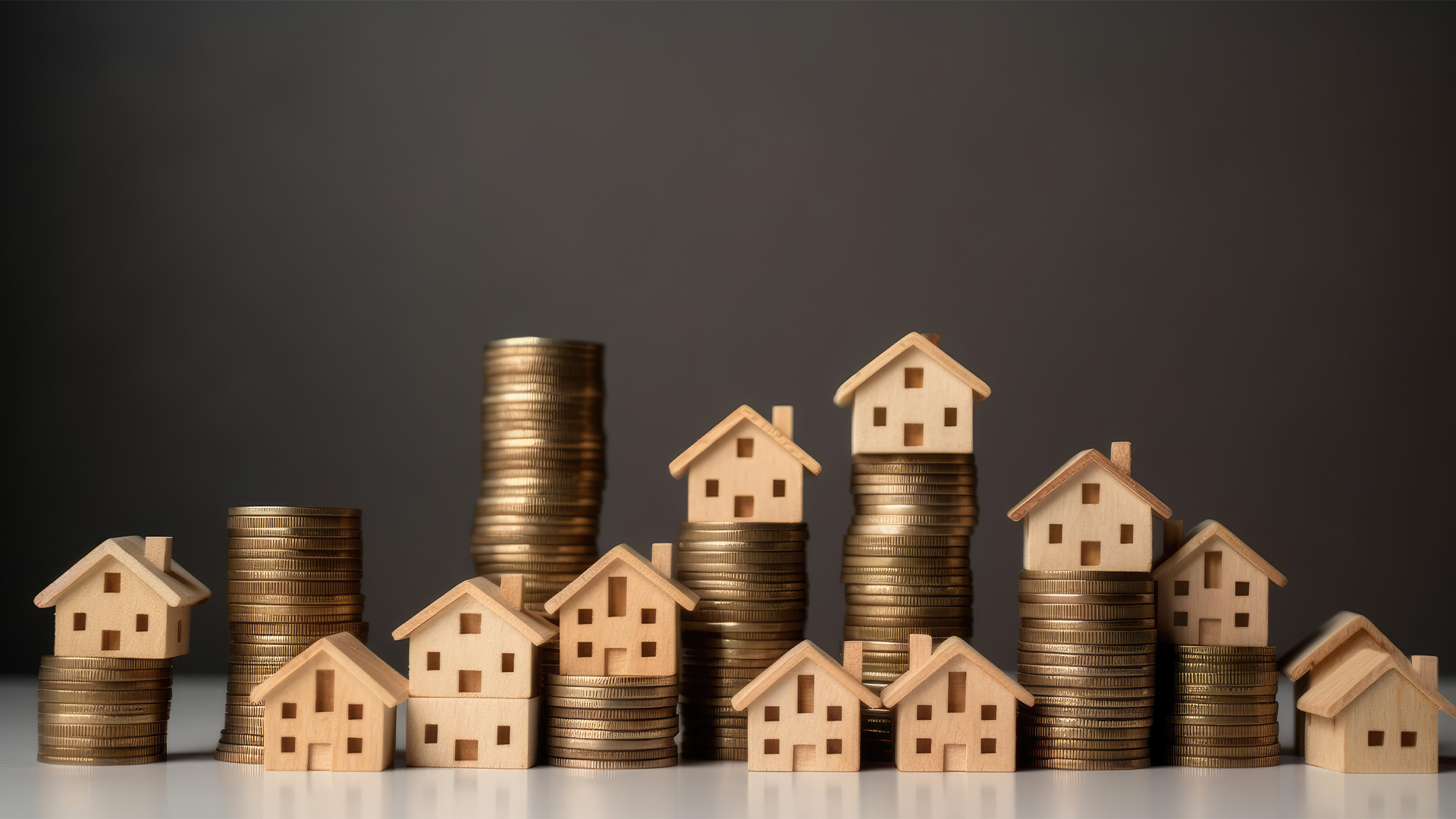 Mini house on stack of coins.